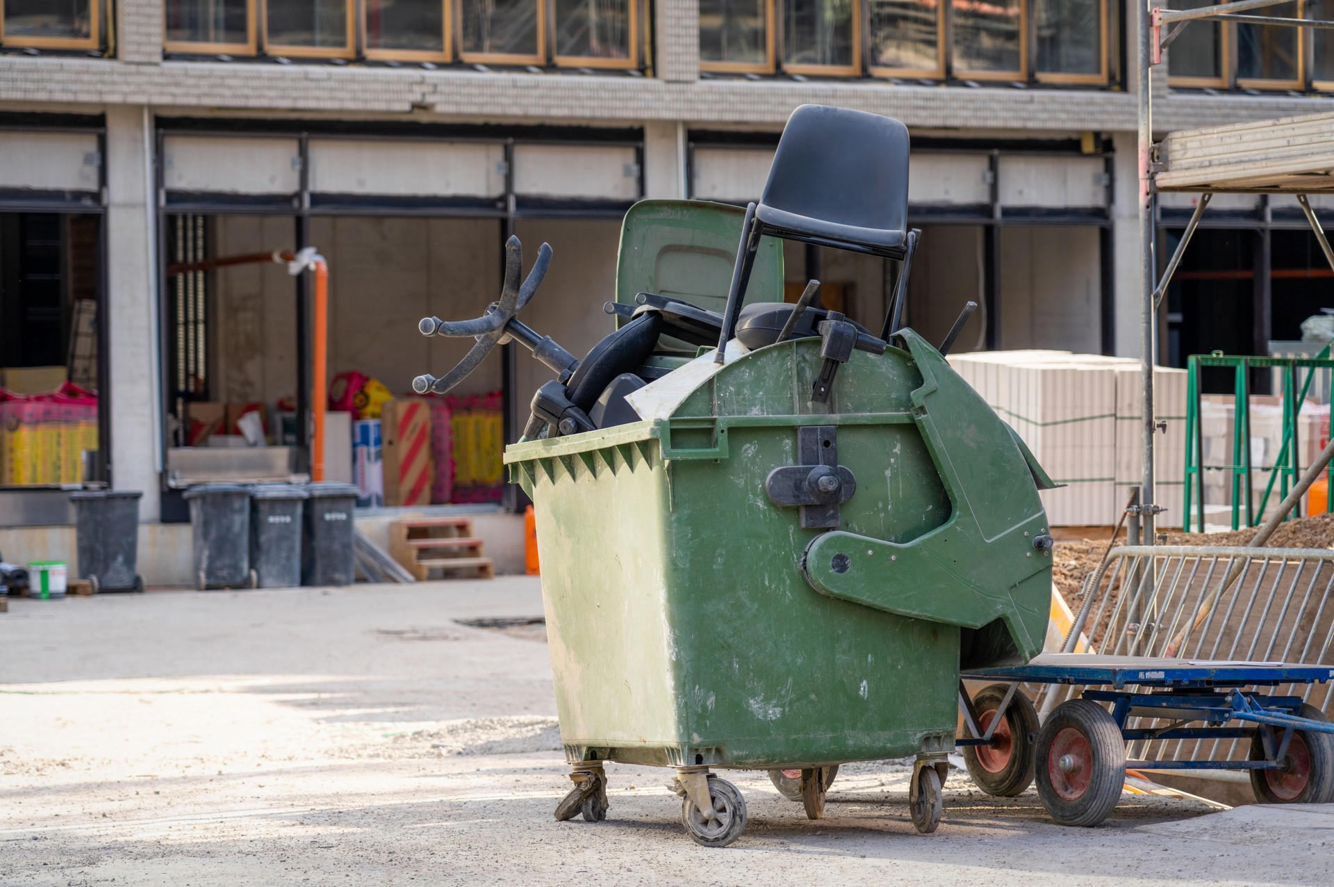 Industrial bin full of office chairs